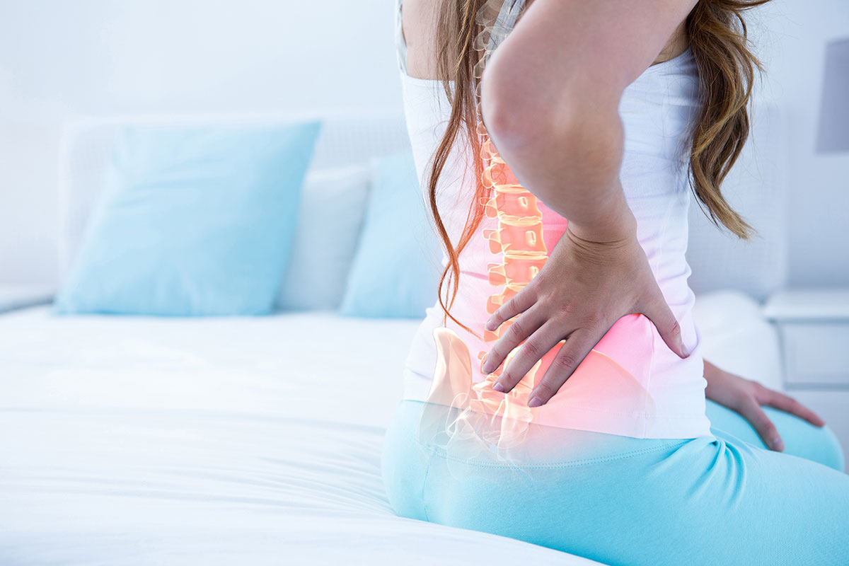 woman rubbing back pain
